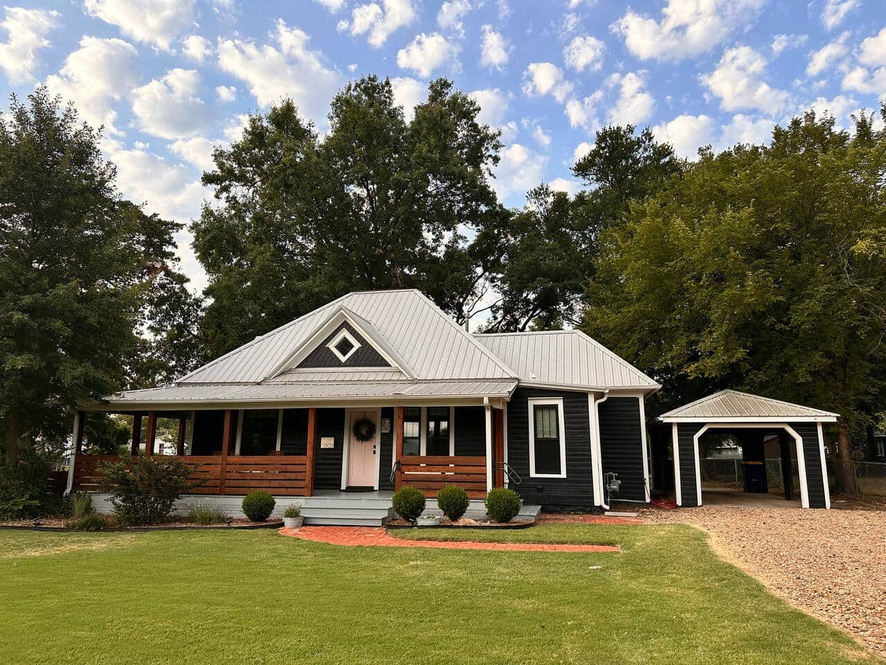 Restored 1922 home featuring a bold black exterior and the iconic pink door of Stillwater.