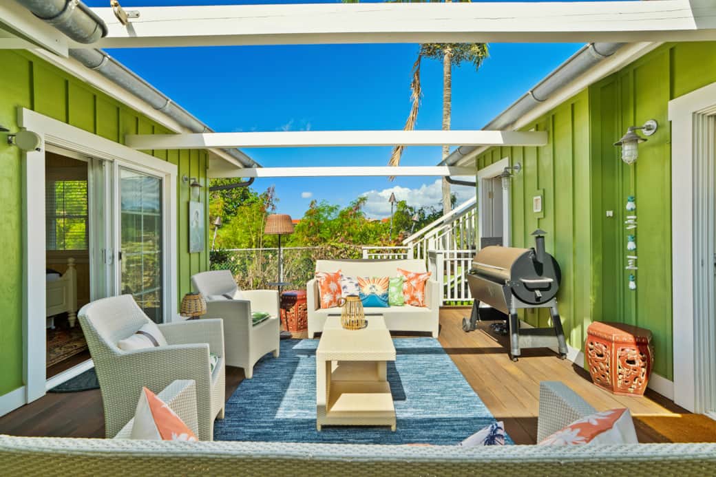 Open-air lanai with comfy seating & BBQ—sunny, private, and steps from both bedrooms.