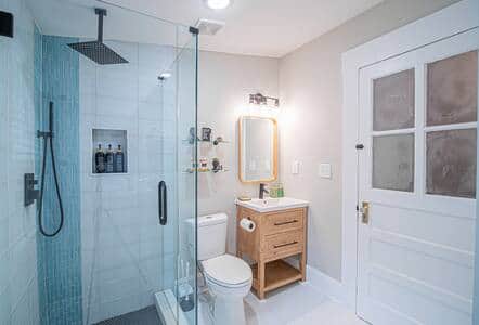 Frameless glass shower create a spa-like ambiance.