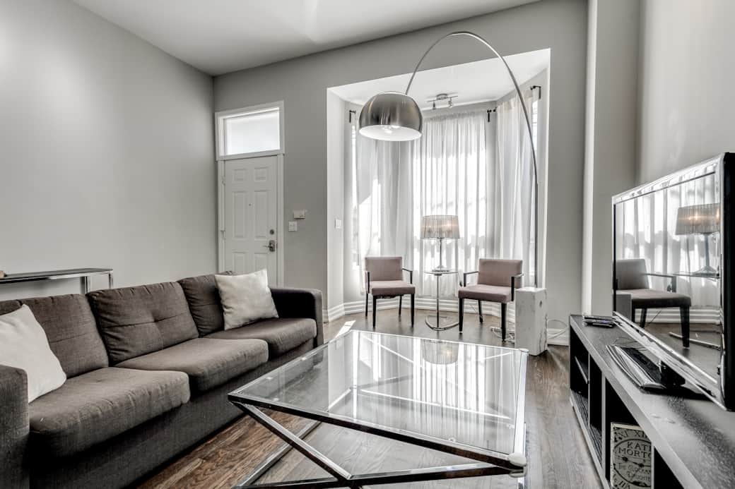 Illuminated and spacious living room in a Toronto high-end short-term rental.