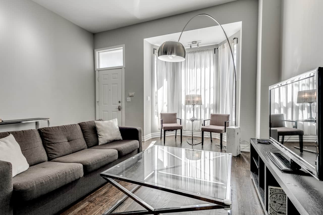 Illuminated and spacious living room in a Toronto high-end short-term rental.