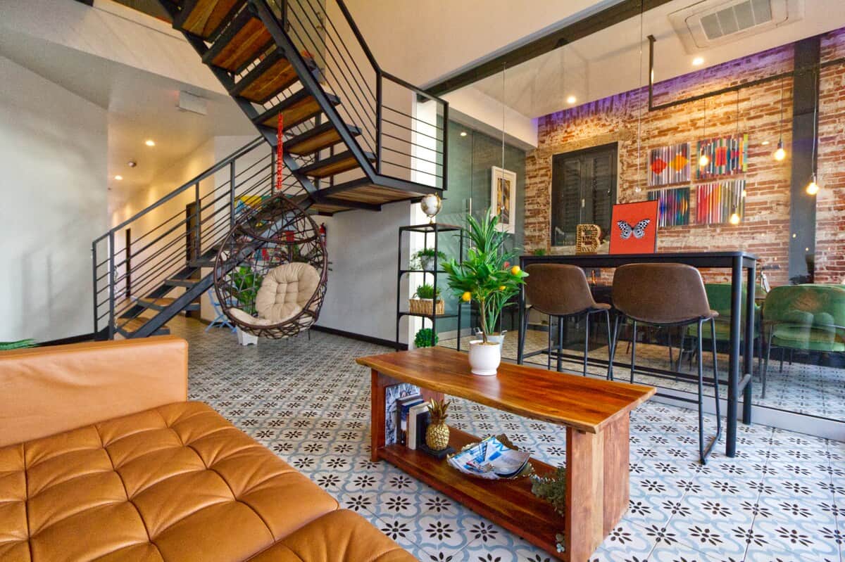 Our building offers a lobby area with a sofa, coffee table, high desk, hanging chair, and small patio table. These amenities are shared with other guests.