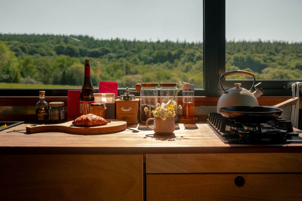 Kitchen counter croissant kettle wildflower woodland view
