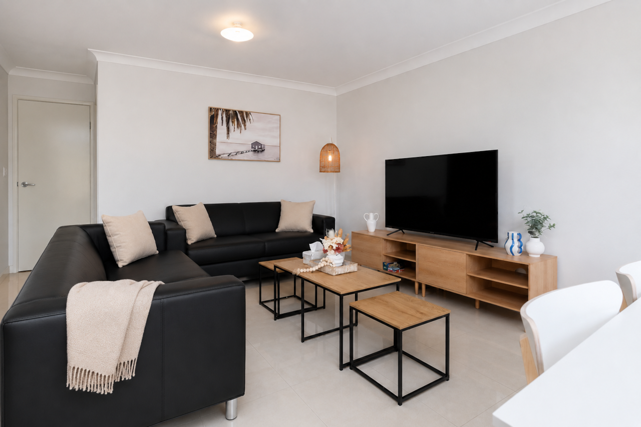 Living Area: Bright living space with comfortable seating and TV 