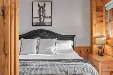 Private bedroom with King bed on main level with access to balcony, hot tub and full bathroom 