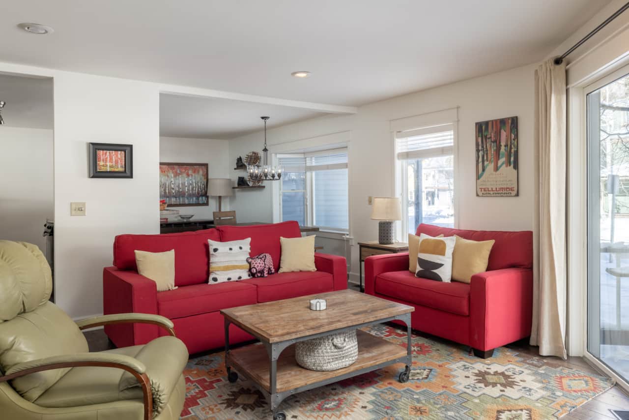 The living room features a queen-sized sleeper sofa for extra bedding