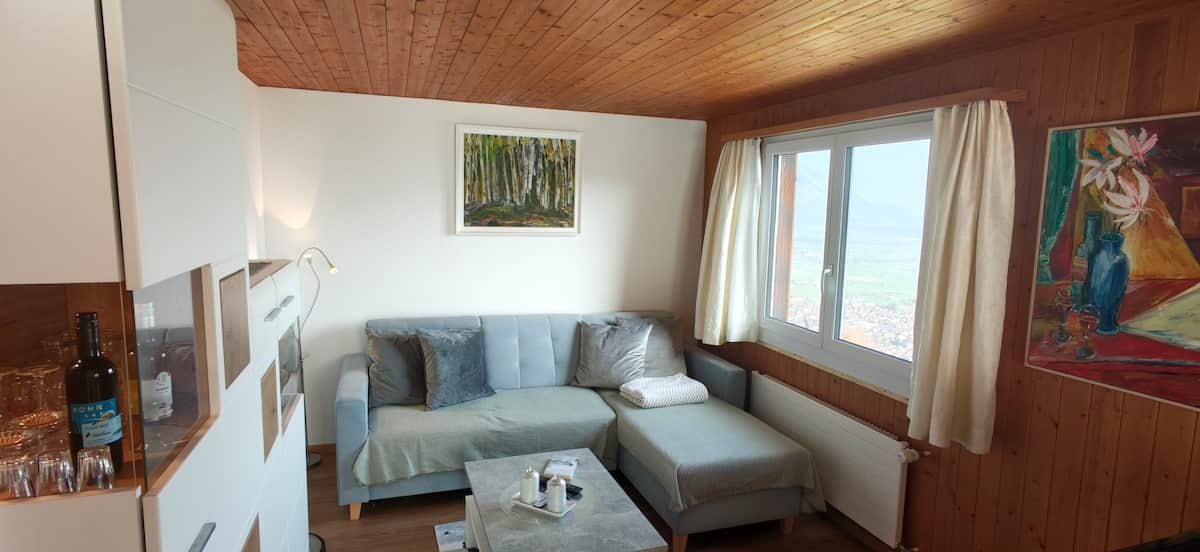 Cosy living room at Nebelmeer Chalet with a fireplace