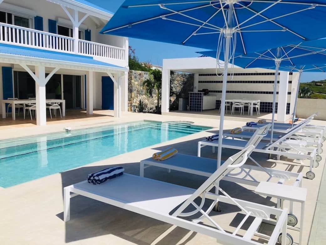 Swimming pool with deck chairs, terrace, and outdoor kitchen Azur