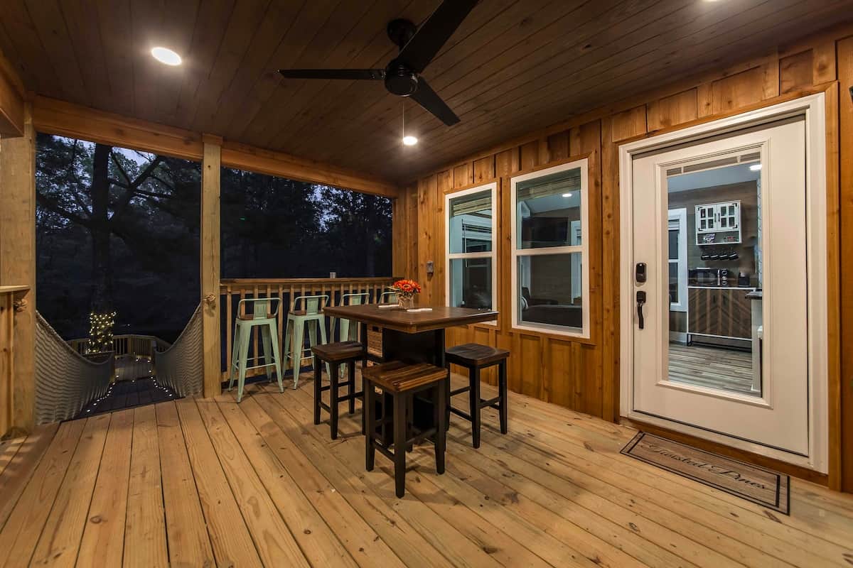 Bar and barstools facing pond with lighted fountain.