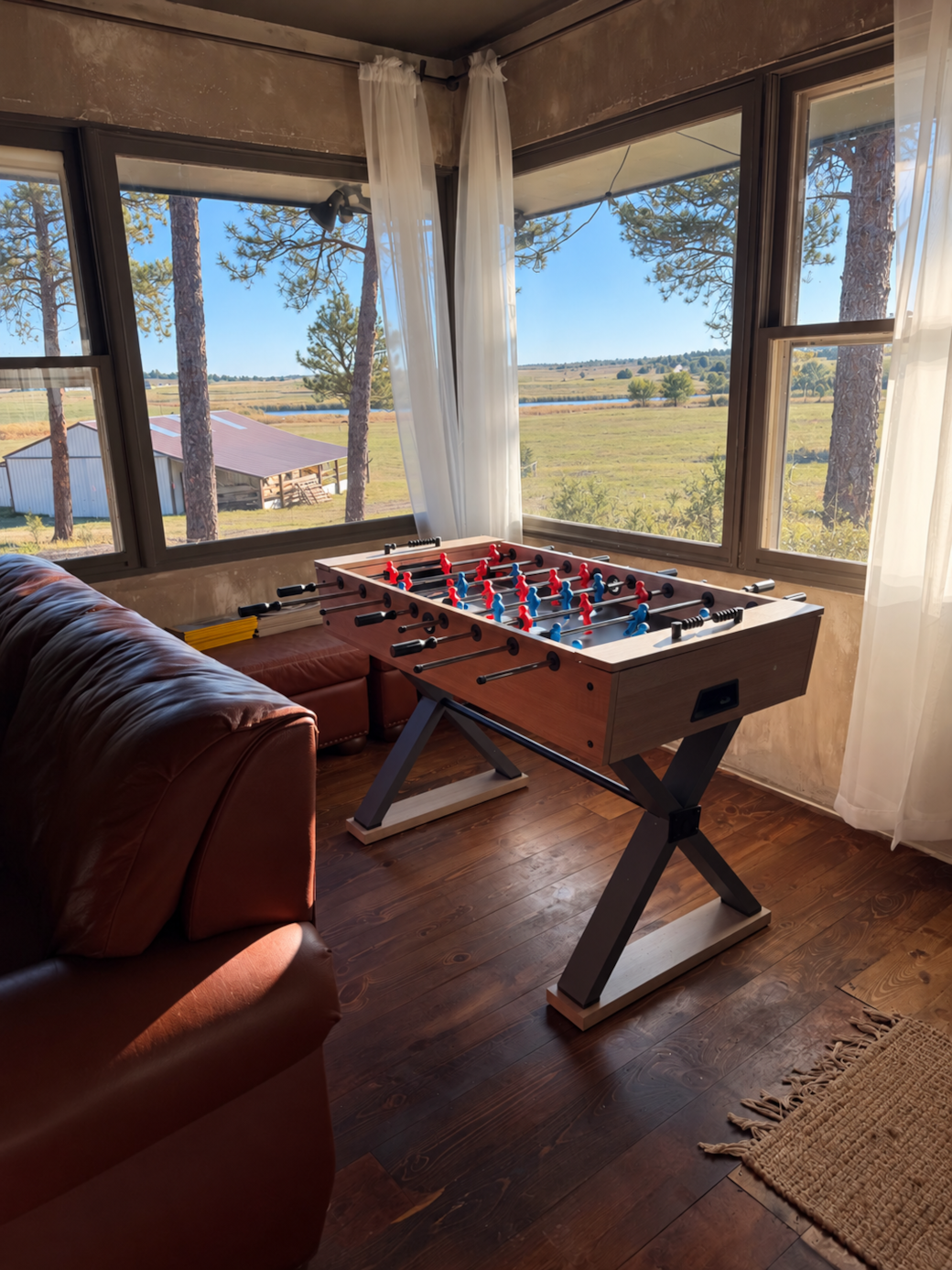 Foosball table and wide windows overlooking the ranch at 4 Spear Lodging
