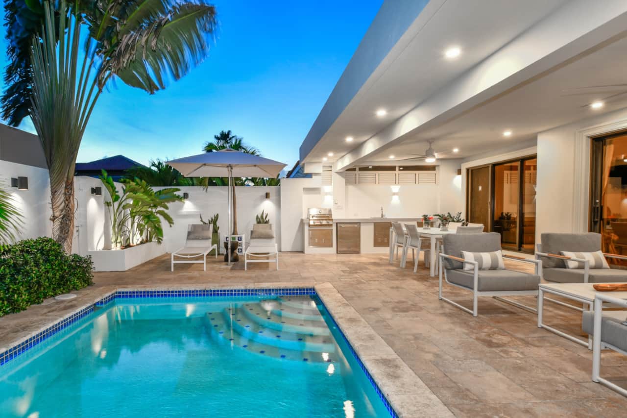 Fully enclose backyard with private pool and gazebo-covered dining and lounging areas