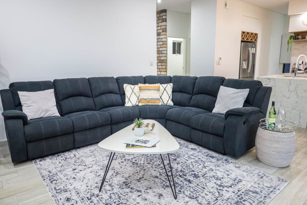 Comfortable corner lounge with built-in recliners—perfect for stretching out and relaxing in style.