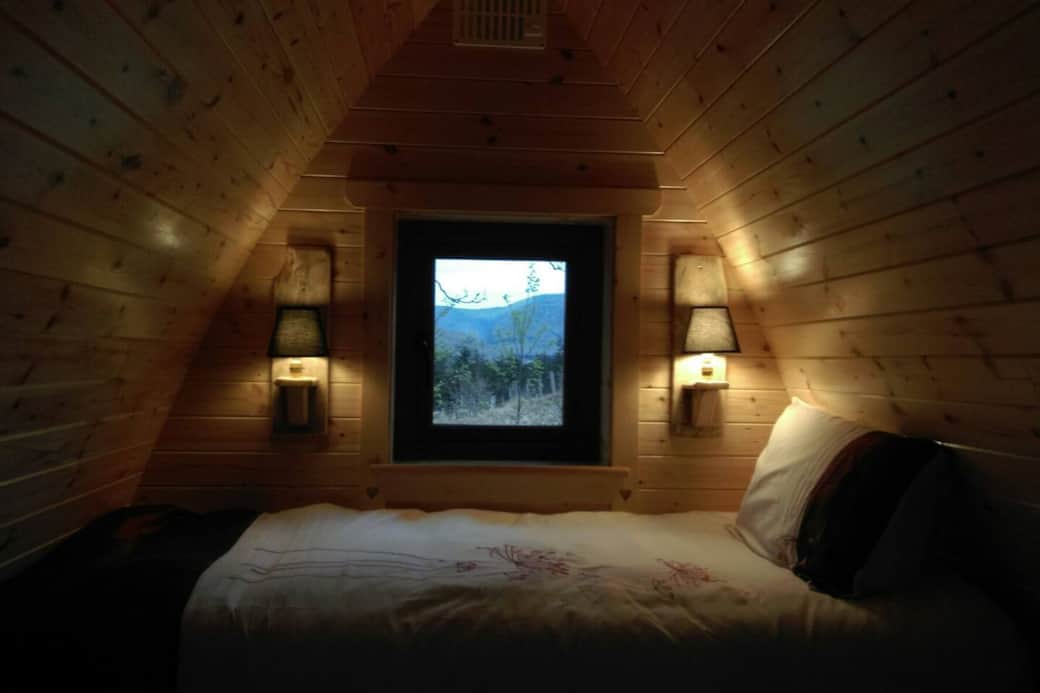 Comfortable bunk bed looking out towards Sheeffry mountains. There are three single beds in the pod. Cosy and warm with electric heater.