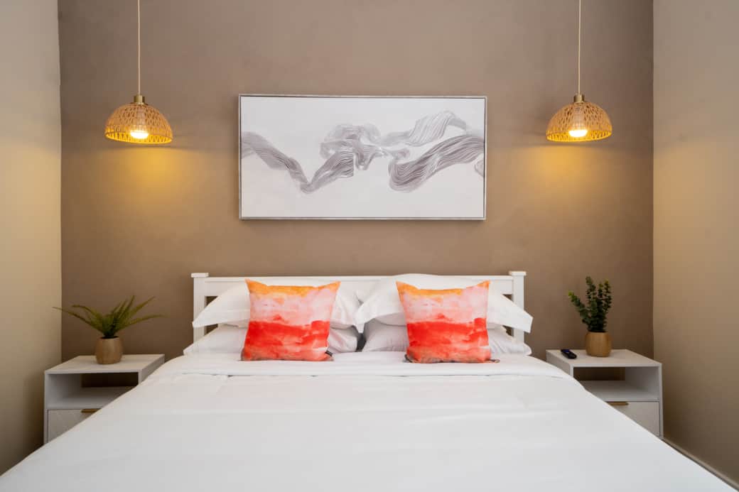 Bedroom 2 - Queen bed with TV and a private bathroom in the hallway