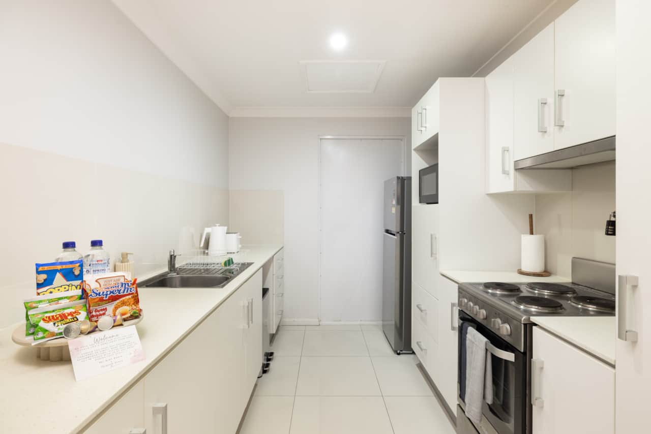 Kitchen: Sleek kitchen with ample storage, modern appliances 