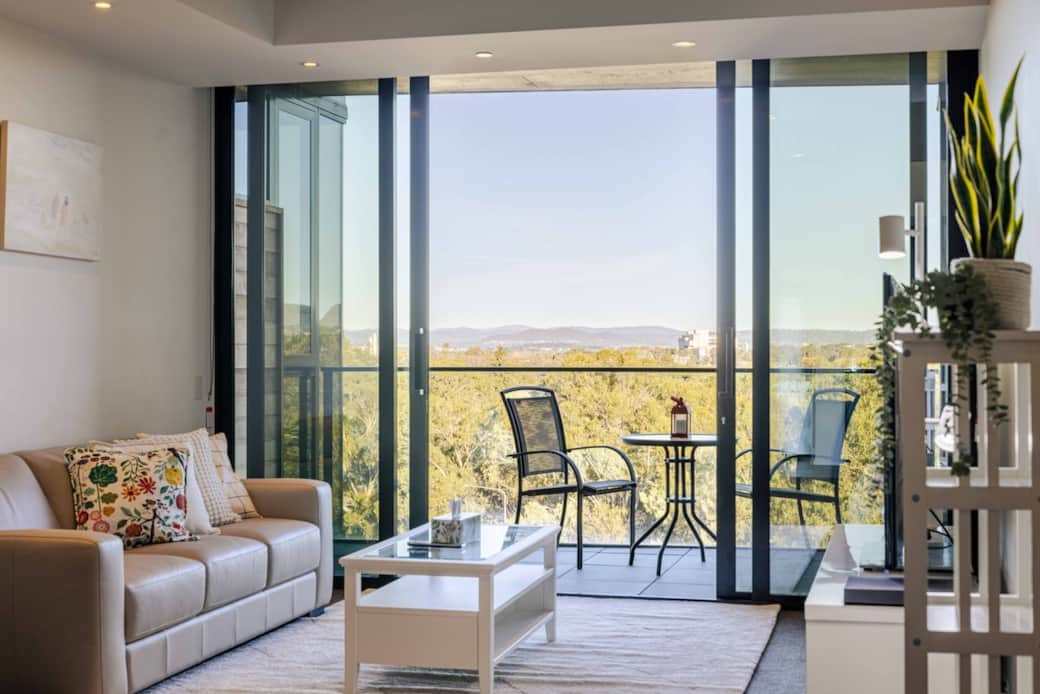 Enjoy breathtaking views from the balcony accessible through the sliding doors. The outdoor setting is perfect for morning coffee or evening relaxation. This space offers a tranquil retreat, blending seamlessly with the modern interior design area.