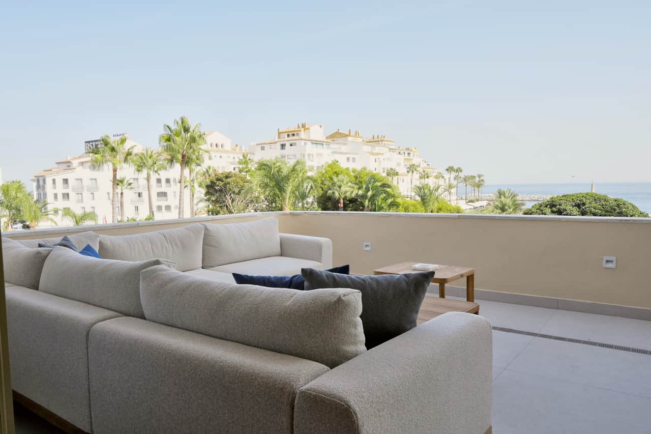 Terrace corner sofa with harbour and sea view