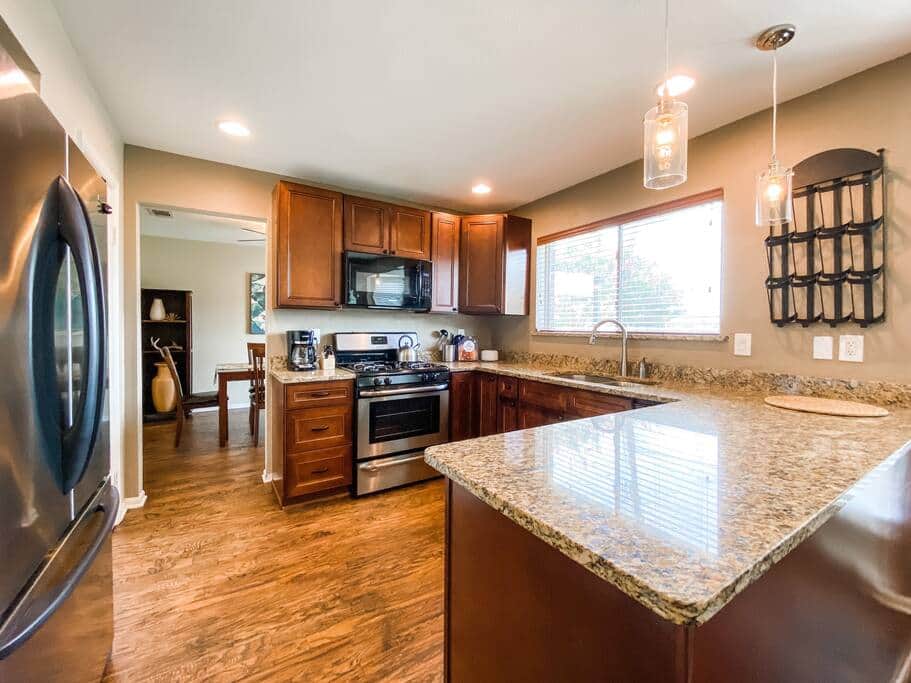 Spacious & bright fully stocked kitchen offers attractive granite counters and new appliances. Spacious & bright fully stocked kitchen offers attractive granite counters and new appliances.