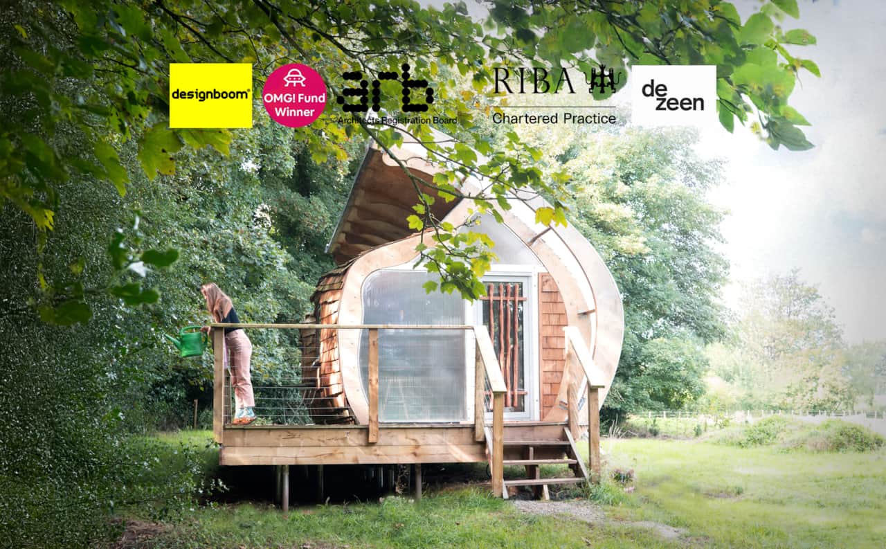 Monocoque Cabin — approaching the cabin through the trees. Cedar-shingle shell, private tree-lined garden, canal.