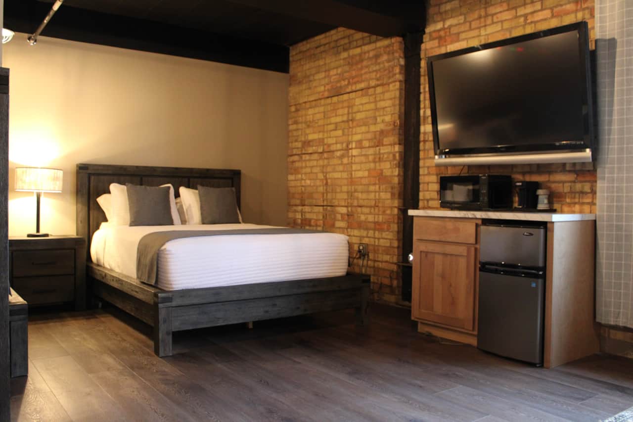 The Markham, bed with television, microwave, fridge