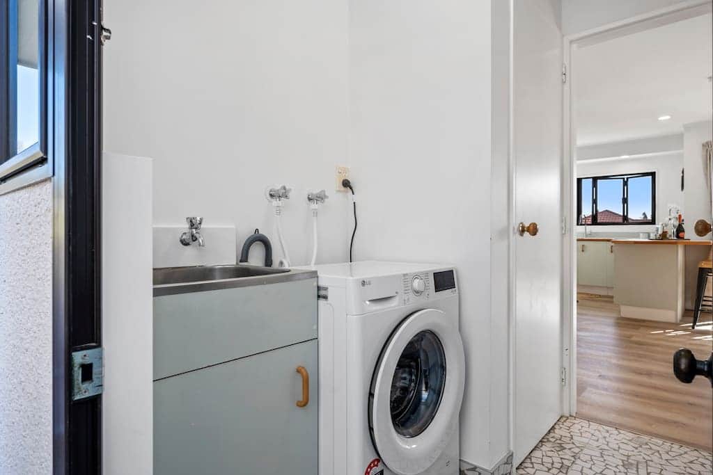 The laundry features an 8kg front-loading washing machine, with a dryer available in the garage.
