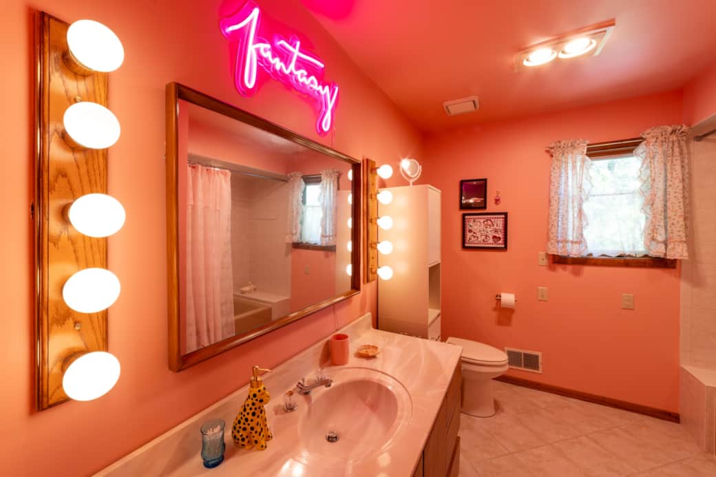 Star Crossed bathroom with neon lights and vintage charm Star Crossed bathroom with neon lights and vintage charm