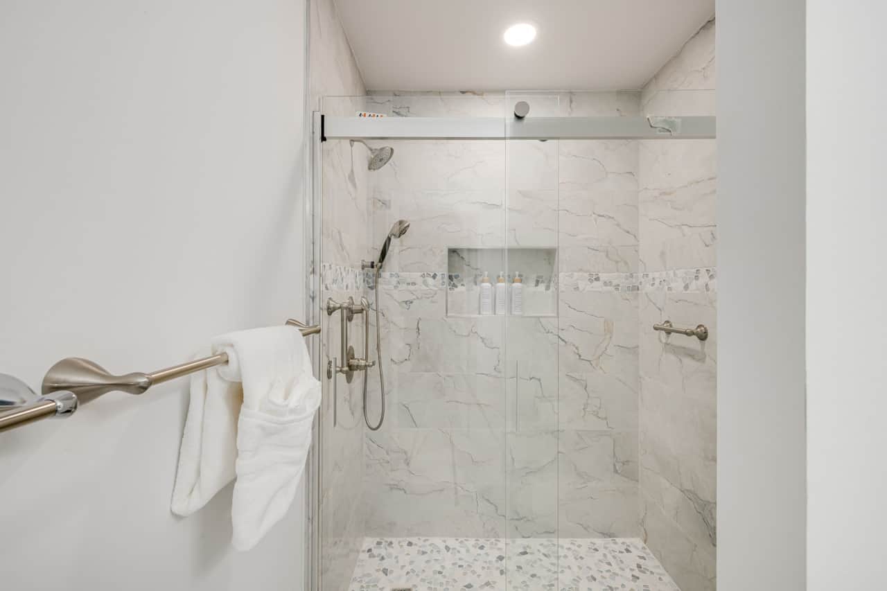 Queen bedroom bath with tile walk-in shower and glass door