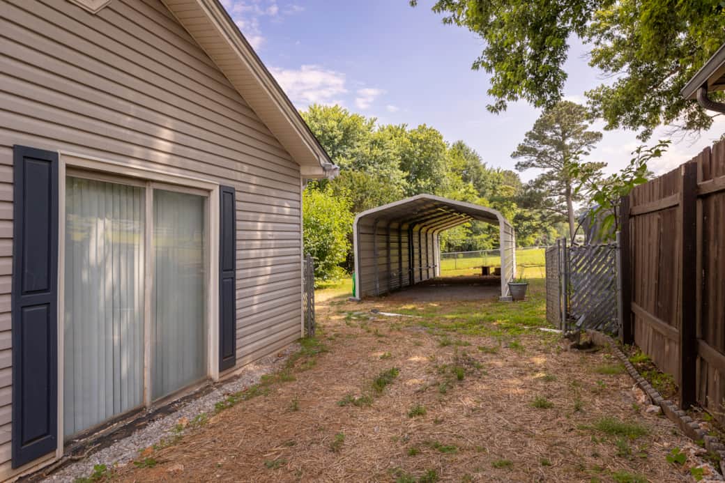 Driveway to covered parking. Fenced in backyard. Driveway to covered parking. Fenced in backyard.