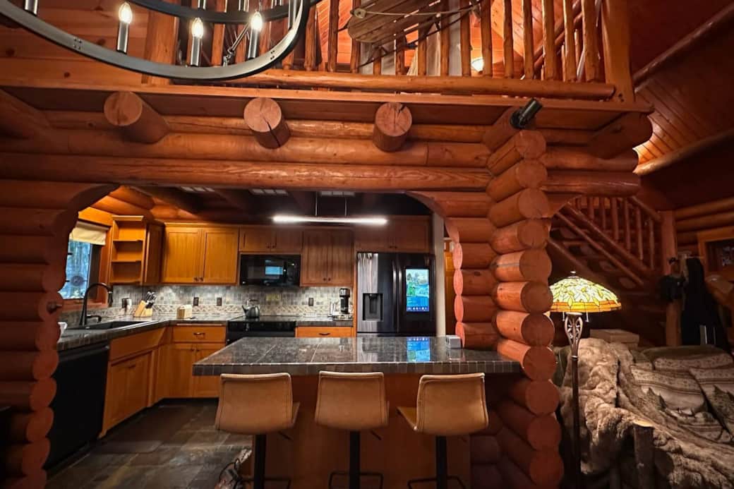 View from the dining bench showing the island and seating area. 