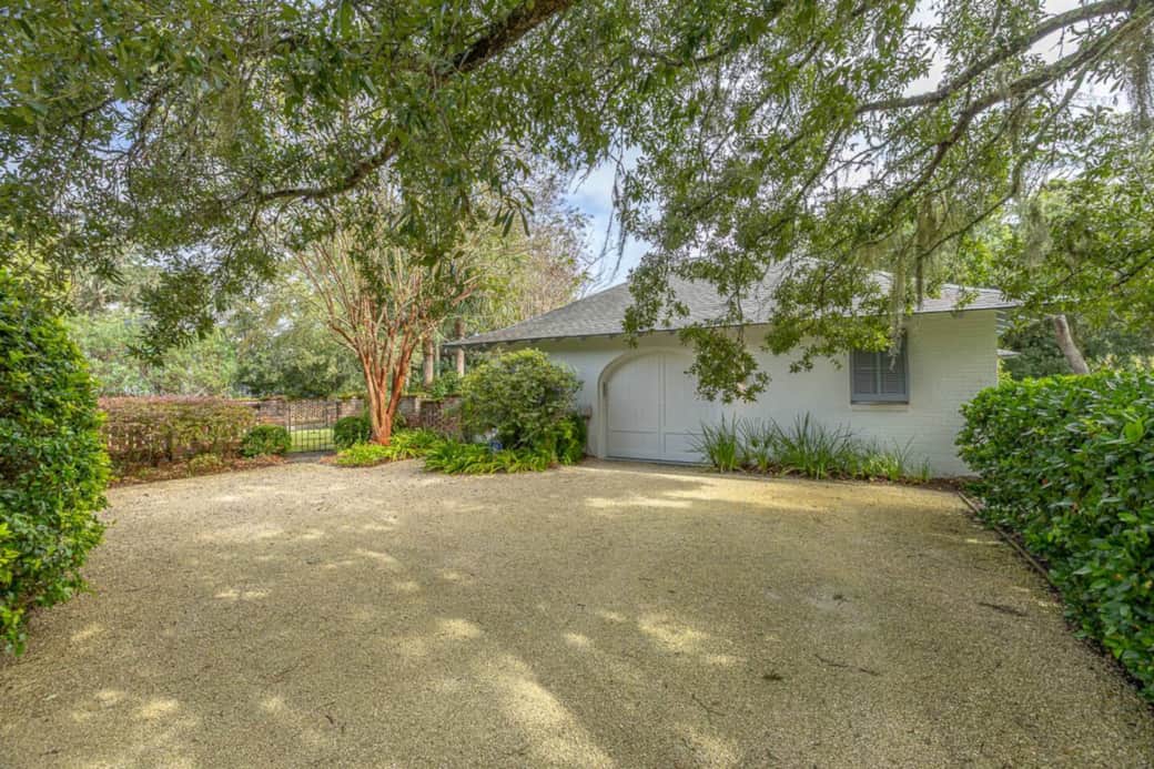 The side entrance to the house is through the garage. There is plenty of parking in the driveway. 