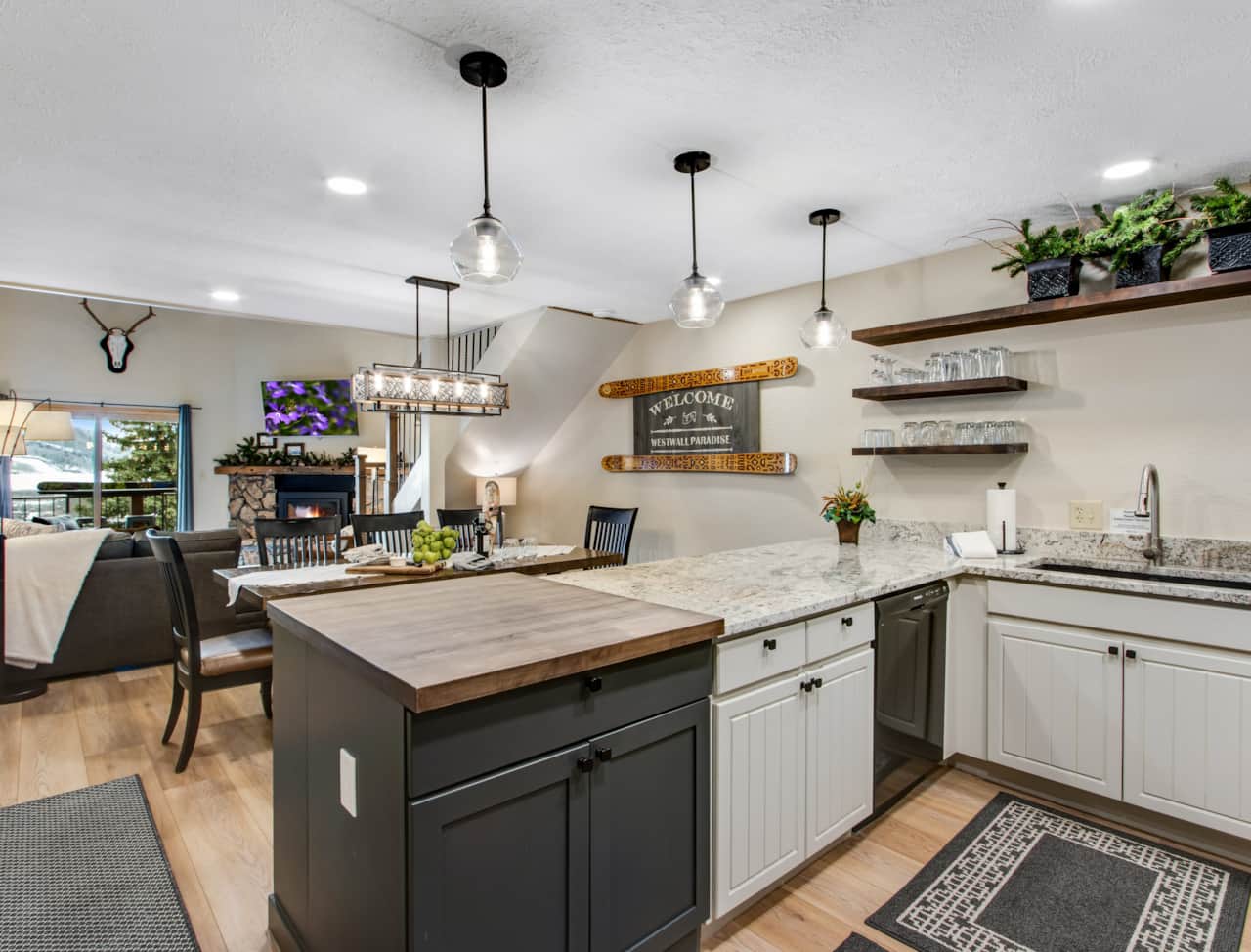 Open floor plan with updated kitchen and modern lighting. Gather with friends in dining area