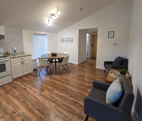 Spacious area featuring a cozy living room, dining space, and nearby kitchen. Lakeland, FL