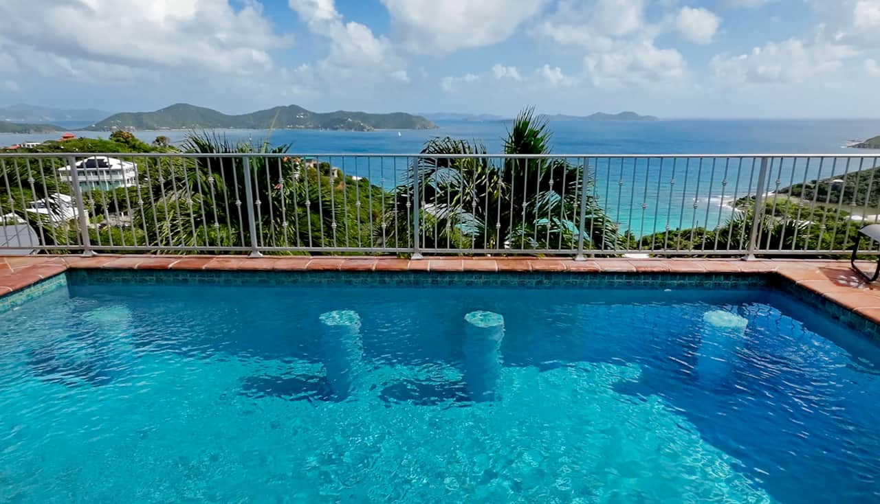 Heated pool features bar stools to hang out and relax