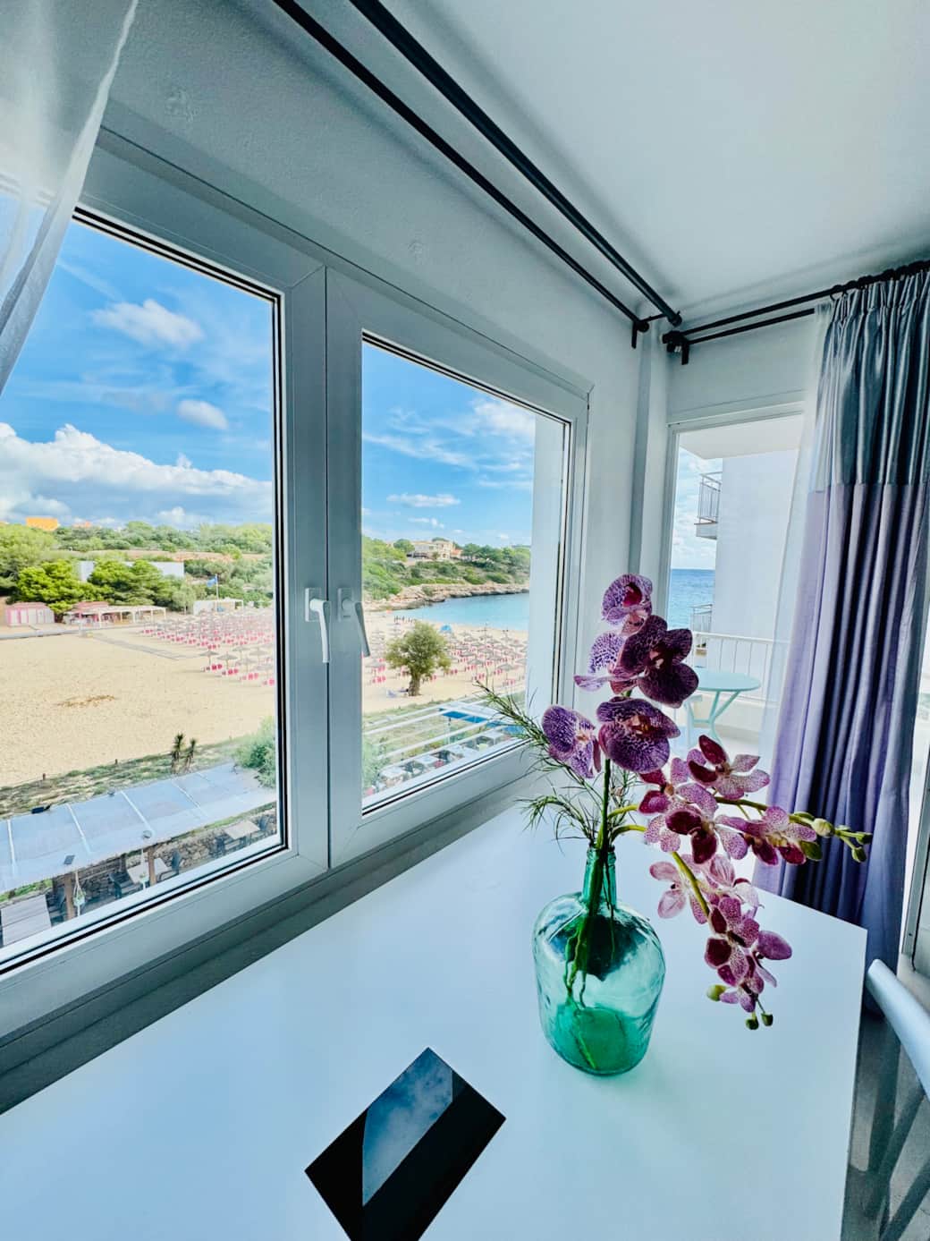 Bright, sun-filled living space with large windows framing the Mediterranean Sea Bright, sun-filled living space with large windows framing the Mediterranean Sea
