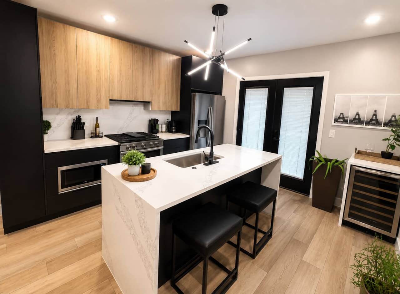  kitchen features quartz countertops, an island with seating, stainless steel appliances, a gas range, a beverage cooler, and stylish finishes throughout. Fully equipped for cooking, it’s the perfect space to prepare meals, enjoy morning coffee.