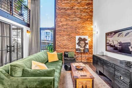 This historic loft features soaring 17 foot ceilings with floor to ceiling windows