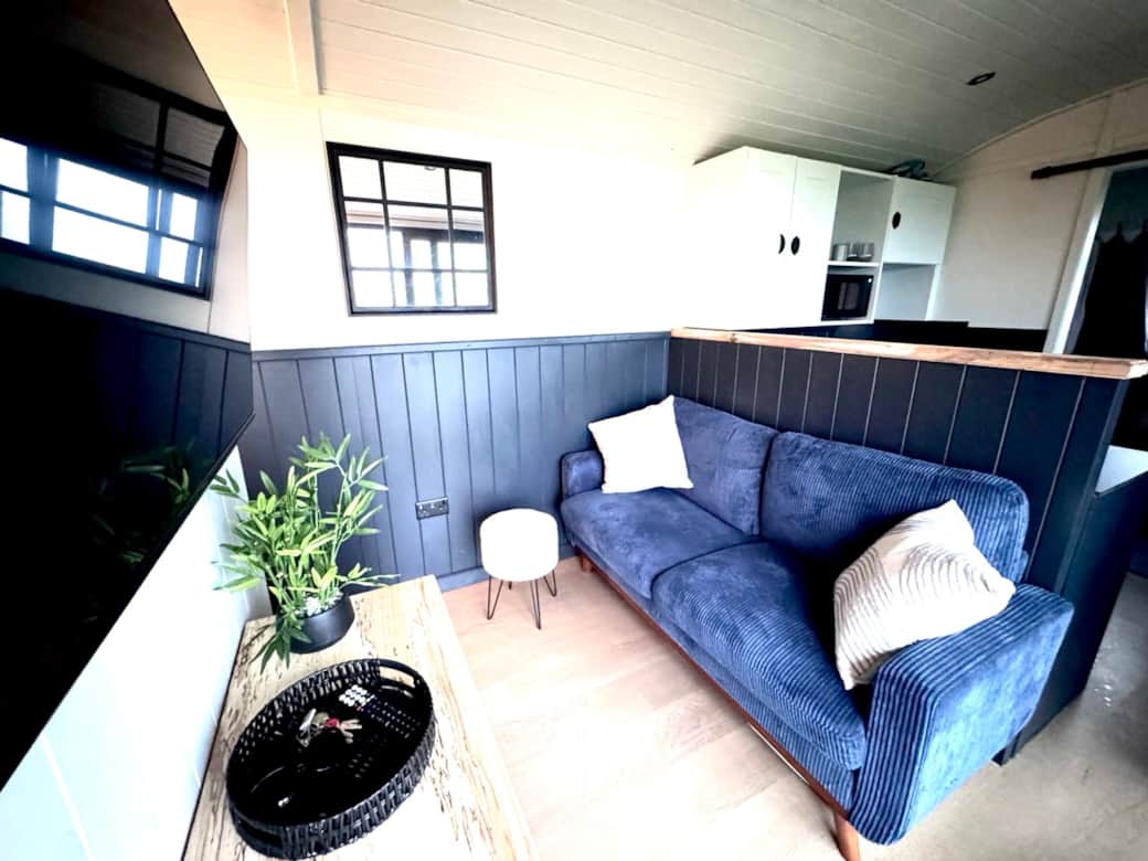 Functional living area with sofa, footstool and smart TV Functional living area with sofa, footstool and smart TV