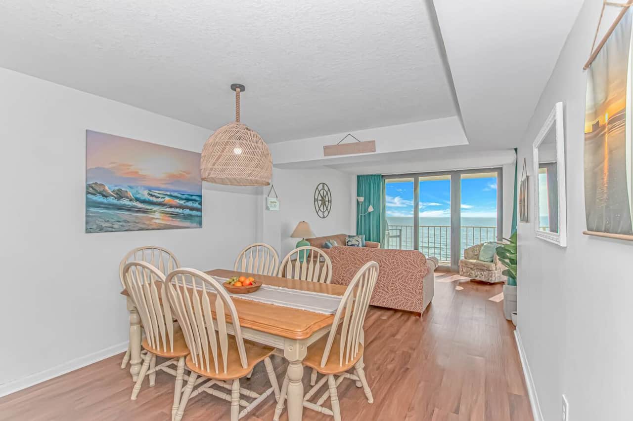 Bright dining area that opens into the cozy oceanfront living room — perfect for meals with a view.