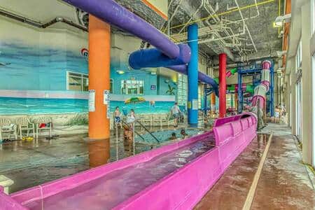 Dunes Village indoor waterpark featuring waterslides, splash areas, and heated pools—open year-round