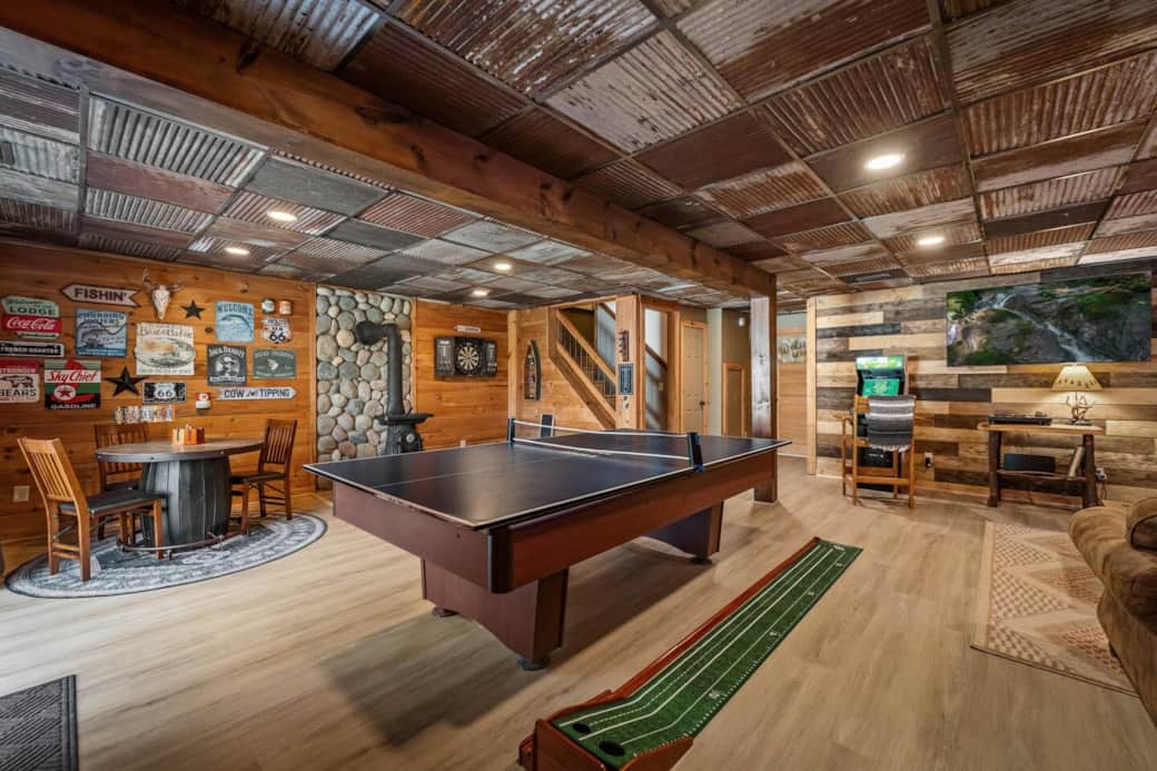 Basement pool/ping pong table, golf putting game, dart board, card table, Golden Tee + Bowling Arcade, and 65” Smart TV.
