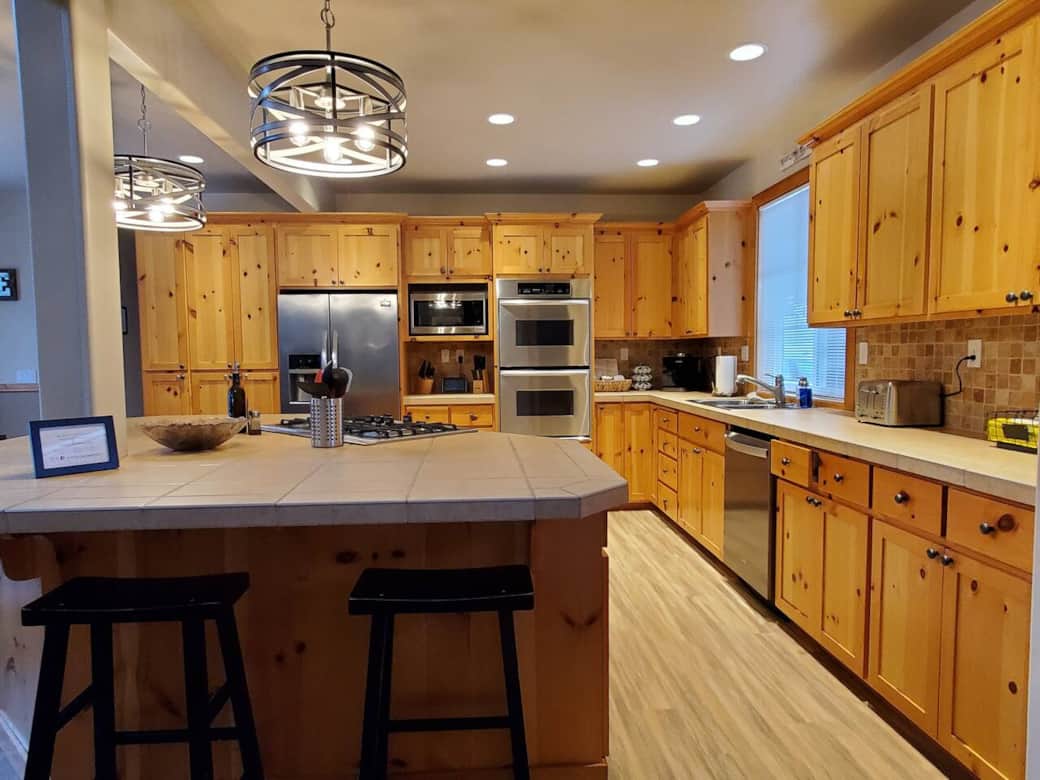 Large gathering kitchen space with plenty of amenities and storage. Double oven, gas stovetop, large microwave, and more.