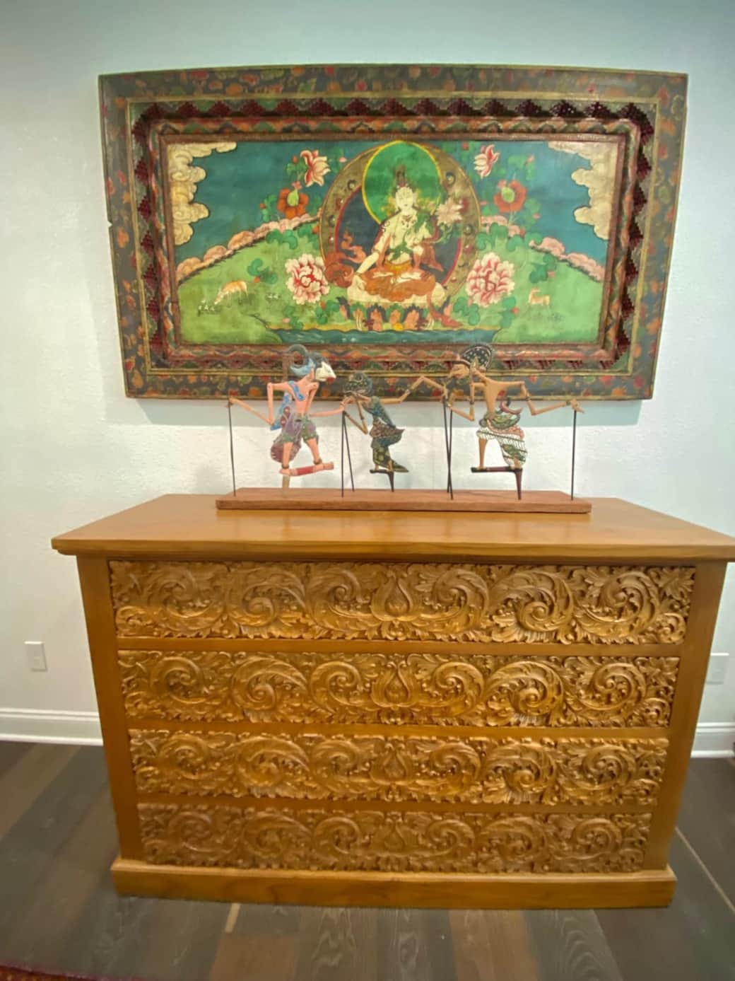 Tibetan painting, Indonesian puppets, and hand carved furnishings from Indonesia