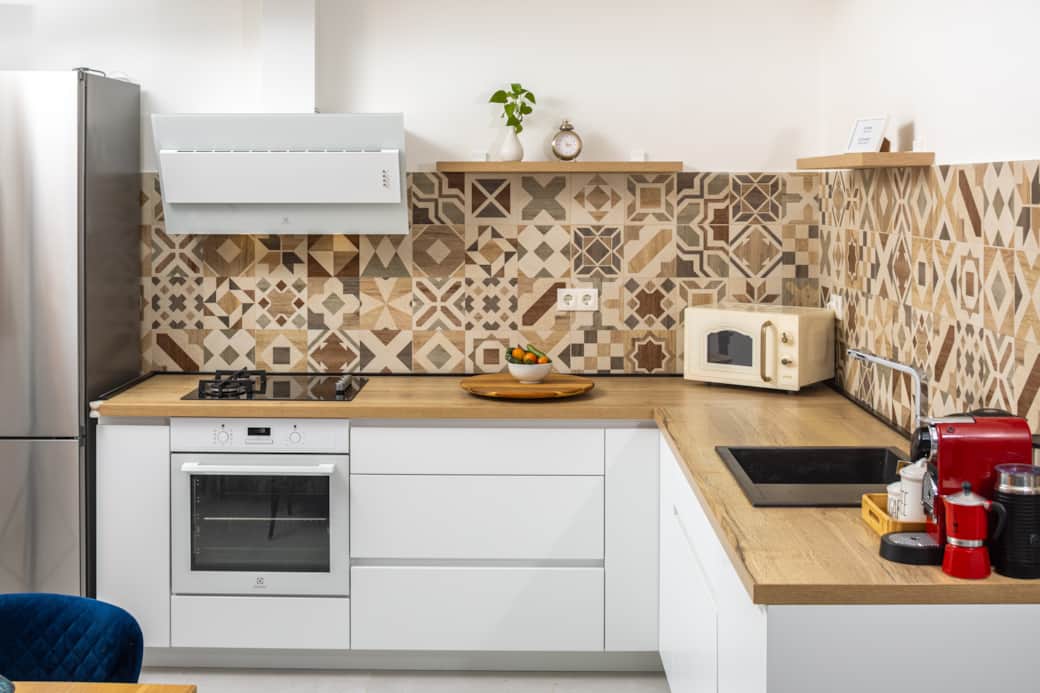 Modern, fully equipped kitchen. Stylish tile backsplash & wood countertops for your culinary journey Modern, fully equipped kitchen. Stylish tile backsplash & wood countertops for your culinary journey