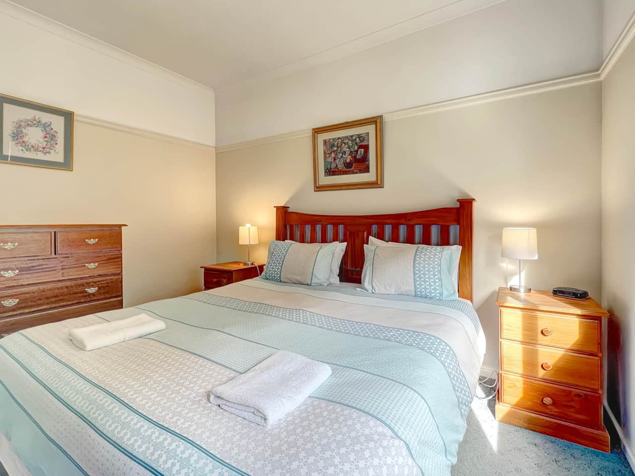 Cozy light-filled bedroom with king bed and electric blankets for chilly nights. Relax and unwind.