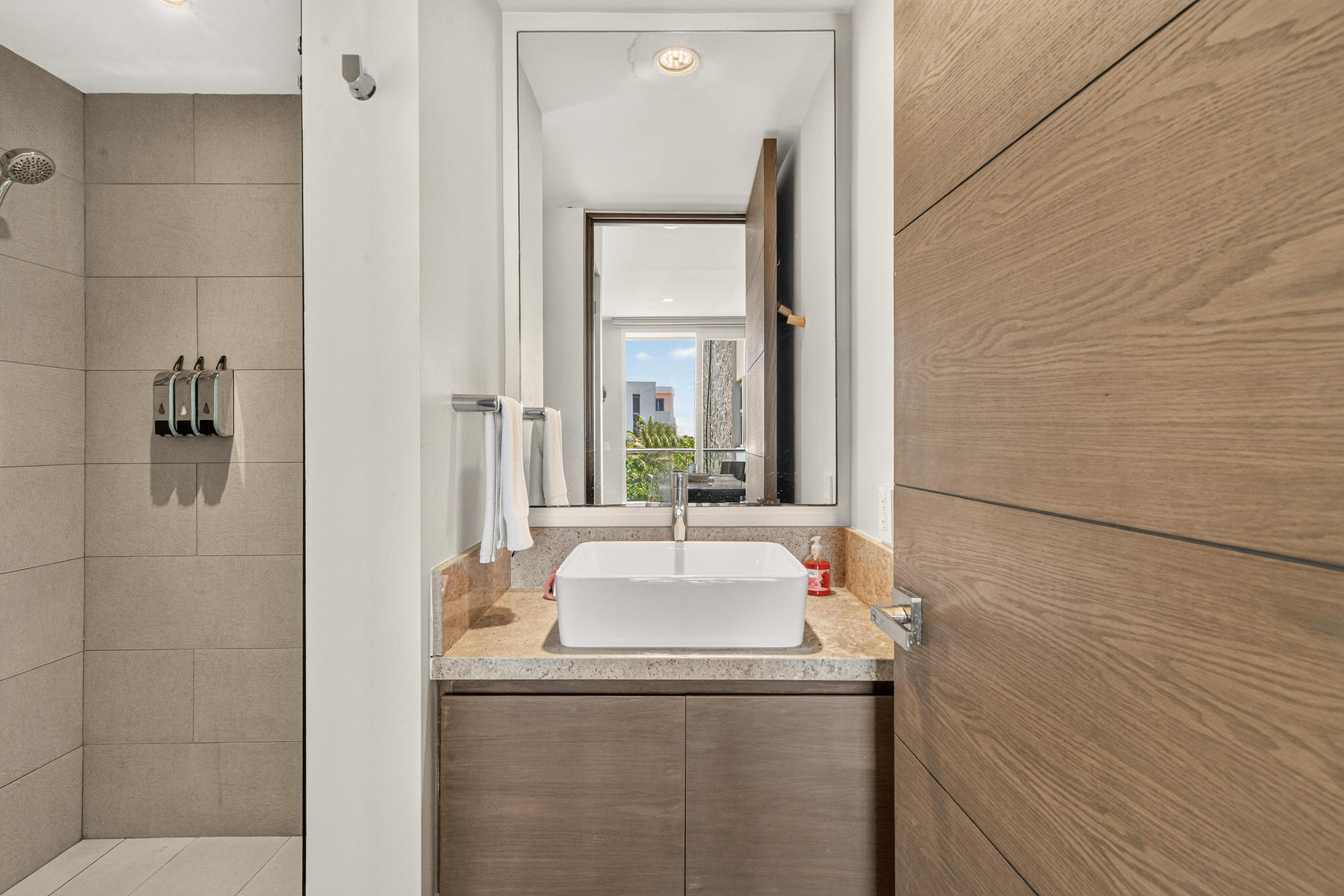 Second bathroom with a walk-in shower, modern finishes, fresh towels and key essential toiletries.
