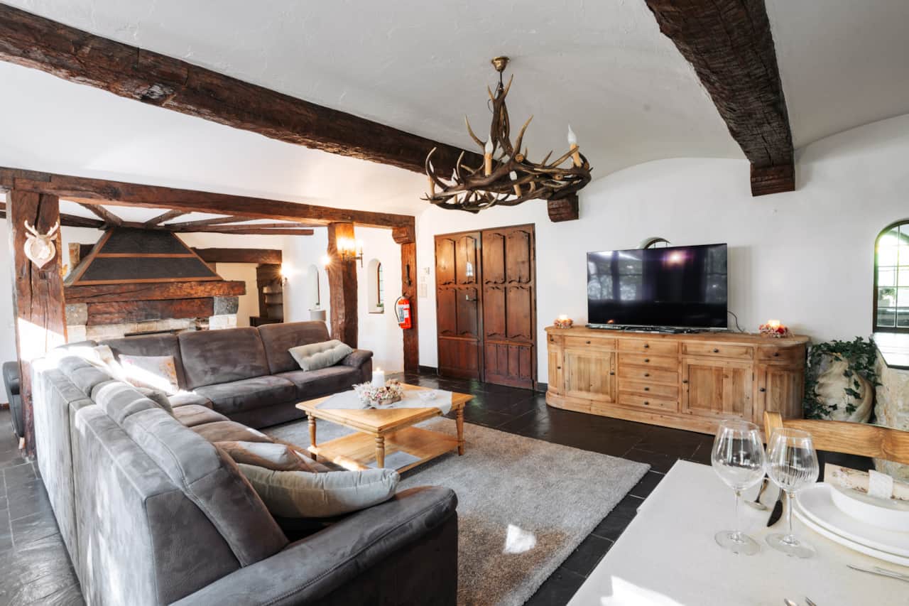 Spacious living room with timber beams and seating