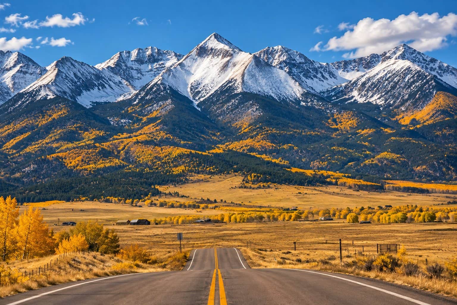 Scenic road through golden fall aspens toward the Sangre de Cristo Mountains near Westcliffe, Colorado