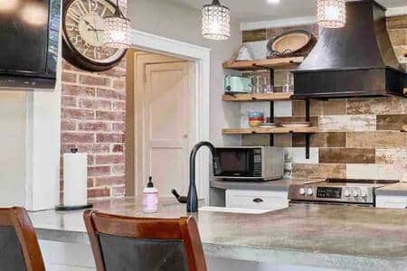 concrete countertops and exposed brick kitchen