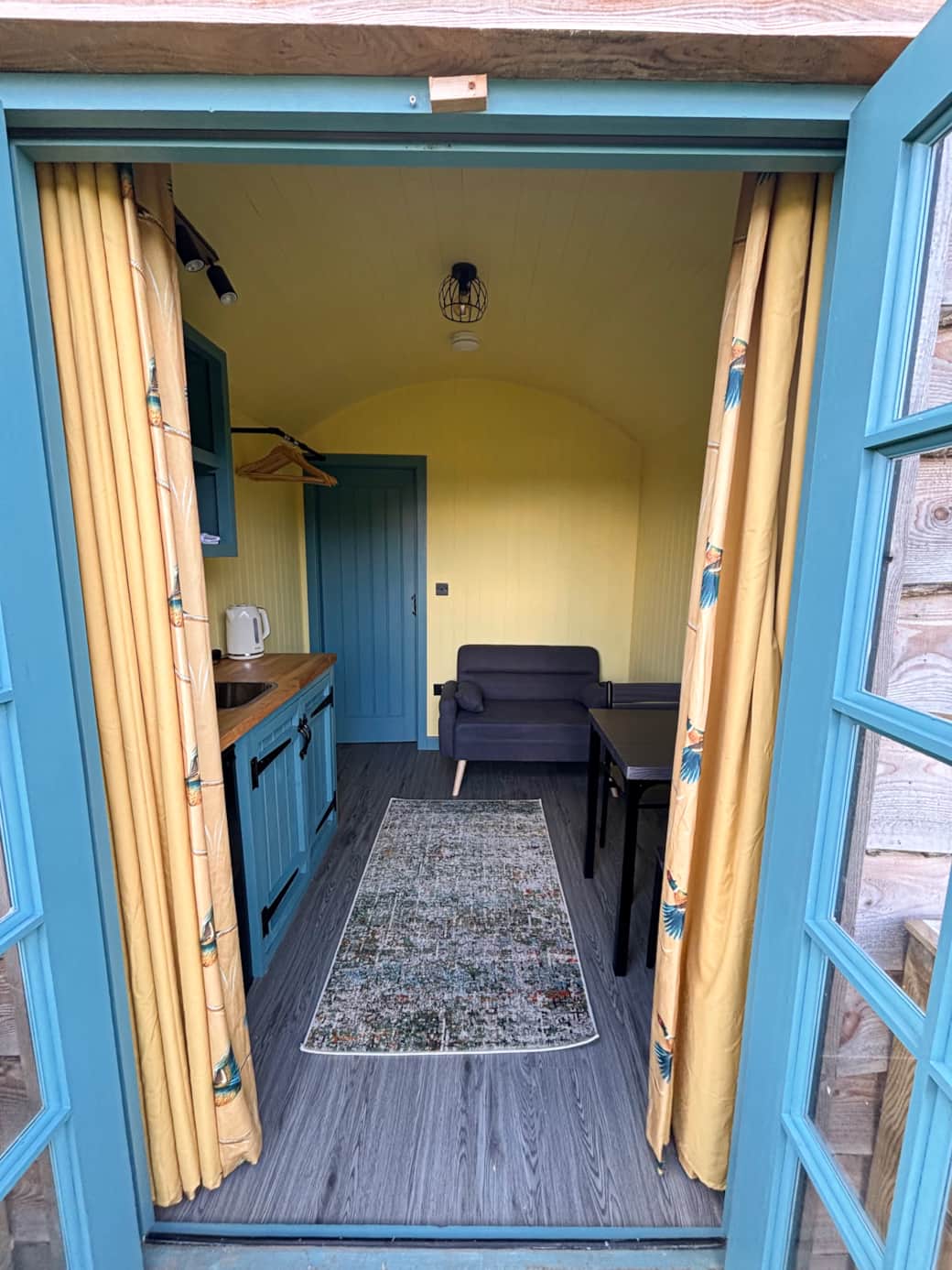 Welcoming entrance with cosy seating and bright country-style interiors.