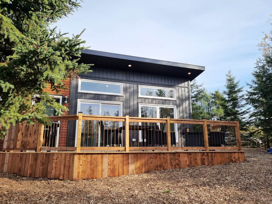 Welcome to The Watervale, a cozy retreat framed by lush trees. 